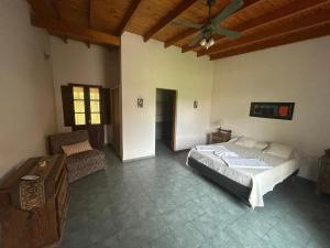 a bedroom with a bed and a ceiling fan at Hosteria Telen in Telén +68 photos