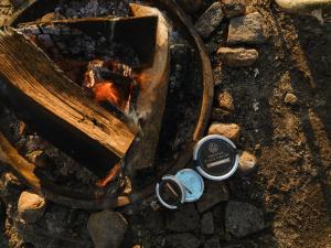 an overhead view of a campfire with a pot and ashes at Nomad Greenland Camp Saqqaq in Saqqaq