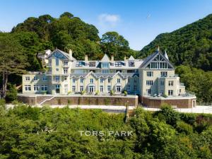 a large house on a hill with trees at Watersmeet Point in Lynmouth