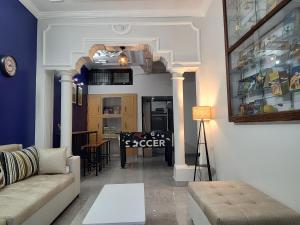 a living room with a couch and a table at Bed N Banter - Lucknow in Lucknow