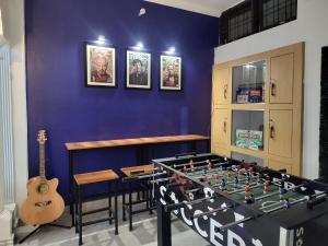 a room with a chess board and a guitar at Bed N Banter - Lucknow in Lucknow +25 photos