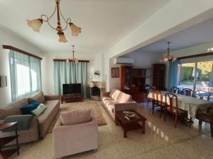 a living room with a couch and a table at Villa Koralia in Peyia