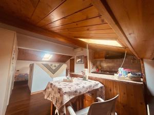 a kitchen with a table and chairs in a room at PERLA Bianca DELLE 5 TERRE in La Spezia