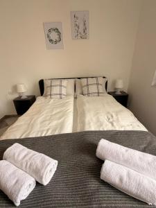 a bedroom with a bed with two towels on it at Levendula Apartman in Bačka Topola