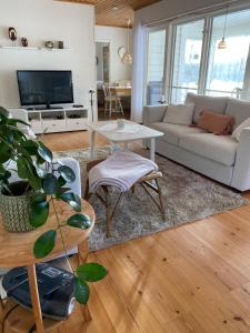 a living room with a couch and a table at Sjösikten in Ätran