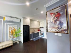 a kitchen with a large painting on the wall at Home MinMimi in Gia Lâm Pho