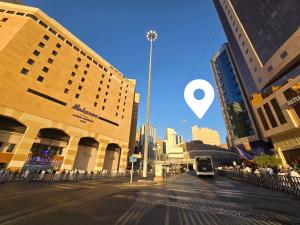 a city street with buildings and a bus at Midhal Al Ezz Ajyad Hotelفندق مدهال العز in Mecca