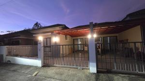 a house with a gate and lights on it at joyful House Naiyang 238 in Nai Yang Beach