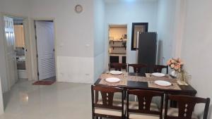 a kitchen and dining room with a table and chairs at joyful House Naiyang 238 in Nai Yang Beach