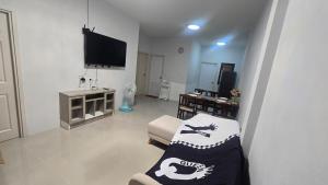 a living room with a couch and a tv at joyful House Naiyang 238 in Nai Yang Beach