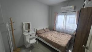 a small bedroom with a bed and a mirror at joyful House Naiyang 238 in Nai Yang Beach