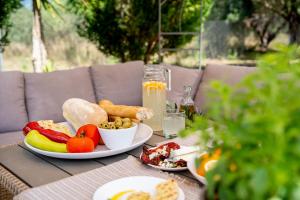 a table with a plate of food on it at Villa Argias Halikounas in Halikounas
