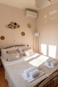 two beds sitting next to each other in a bedroom at Villa Argias Halikounas in Halikounas +11 photos