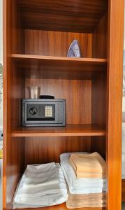 a book shelf with a radio in a closet at PB326 Beautiful studio in Phuket in Ban Mai Salae