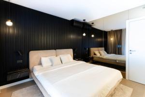 a bedroom with a white bed and a black wall at Luxury Villa Palermo in Vir +42 photos