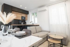 a living room with a couch and a table at Apartman Turcic in Malinska