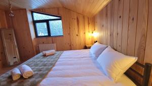 a bedroom with a bed with two pillows on it at Guesthouse Laurbili in Mestia