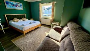 a bedroom with a couch and a bed and a window at Lomond Park Hotel in Balloch +37 photos