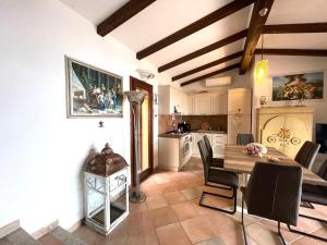 a kitchen and dining room with a table and chairs at Villa La Dolce Vista & Private hydro pool in Costa Paradiso