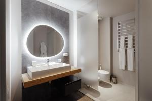 a bathroom with a sink and a mirror at Il Decameron Luxury Design Hotel in Odesa