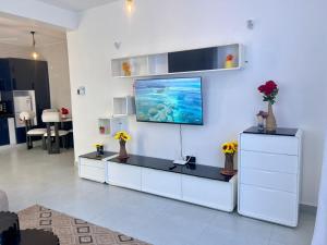 a living room with a tv on a white wall at DIANI 2 Bed STUDIO in Gatunga