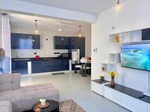 a living room with a couch and a kitchen at DIANI 2 Bed STUDIO in Gatunga