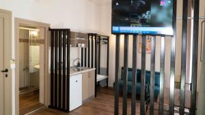 a bathroom with a tv on a wall at ISIDORA home in Rethymno