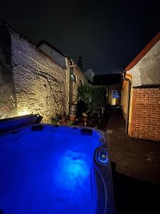 a blue car parked in front of a building at night at Tessa Central House in Kőszeg