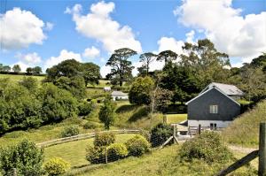 a black and white house on a hill with a fence at The Roost in Saltash