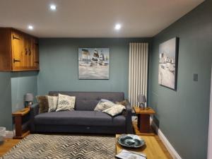 a living room with a couch and a table at The Roost in Saltash