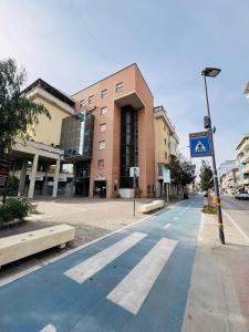 an empty street in front of a brick building at Solaria House in Montesilvano