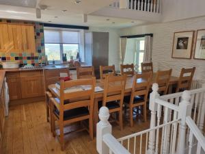 a kitchen and dining room with a table and chairs at The Estate in Saltash