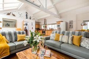 a living room with two couches and a table at The Estate in Saltash
