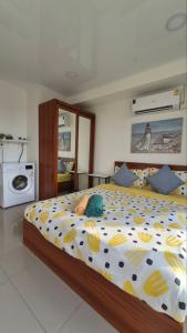 a bedroom with a large bed with yellow and blue pillows at PB326 Beautiful studio in Phuket in Ban Mai Salae +11 photos