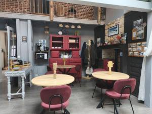 a room with two tables and chairs and a kitchen at Chambres d'hôtes Atypik in Dieppe