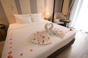 a hotel room with a bed with a bunny on it at San Hotel & Pool in Hanoi +17 photos