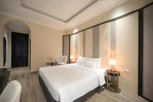 a large white bed in a hotel room at San Hotel & Pool in Hanoi