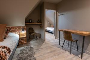a bedroom with a bed and a table and chairs at La Briqueterie in Saint-Aubin +80 photos