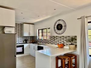 a kitchen with white cabinets and a counter top at 4 Laddswood Lodge in Hilton