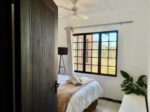 a bedroom with a bed and a large window at 4 Laddswood Lodge in Hilton