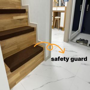 a stairway with a safety guard on the bottom of a stairway with wood at The Comfort in Seoul