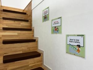 a staircase with wooden floors and signs on the wall at The Comfort in Seoul +24 photos
