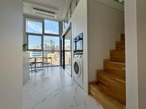 a laundry room with a washer and dryer in a house at The Comfort in Seoul