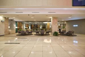a lobby of a hotel with chairs and tables at 퀸벨호텔 in Tōson