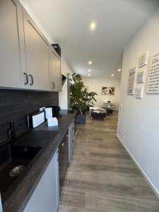 a kitchen with black counter tops and white cabinets at City Lounge Bielefeld 005 in Bielefeld