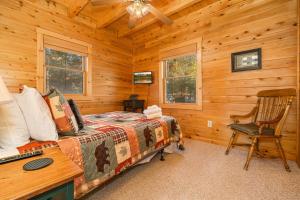 a bedroom with a bed and a desk in a cabin at A Wispful Dream in McHenry