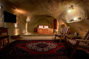 a bedroom with a bed in a stone room at Babili Cappadocia Cave in Nevşehir