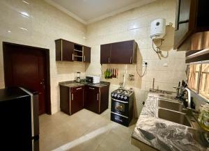 a kitchen with a sink and a stove at Resmay apartment in Abuja
