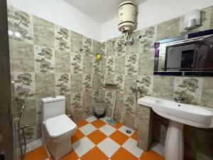 a bathroom with a toilet and a sink at Valley View in Dhanaulti +21 photos