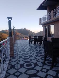 a patio with chairs and tables on a balcony at Valley View in Dhanaulti
